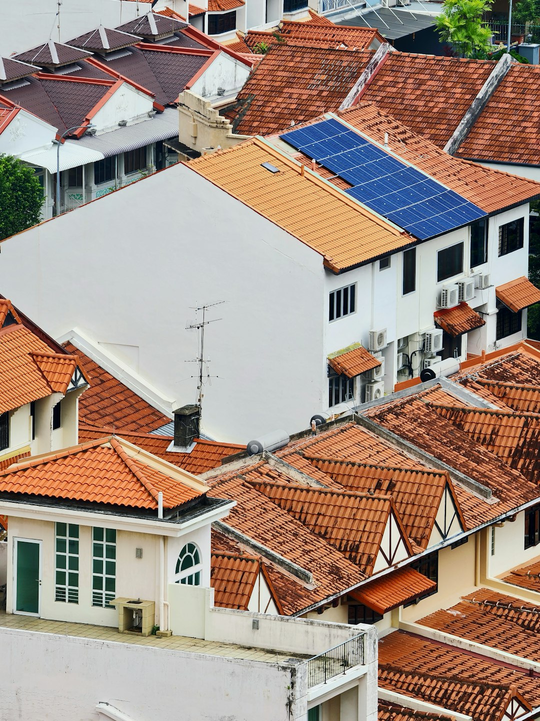 Residential rooftop with solar panels under blue sky
